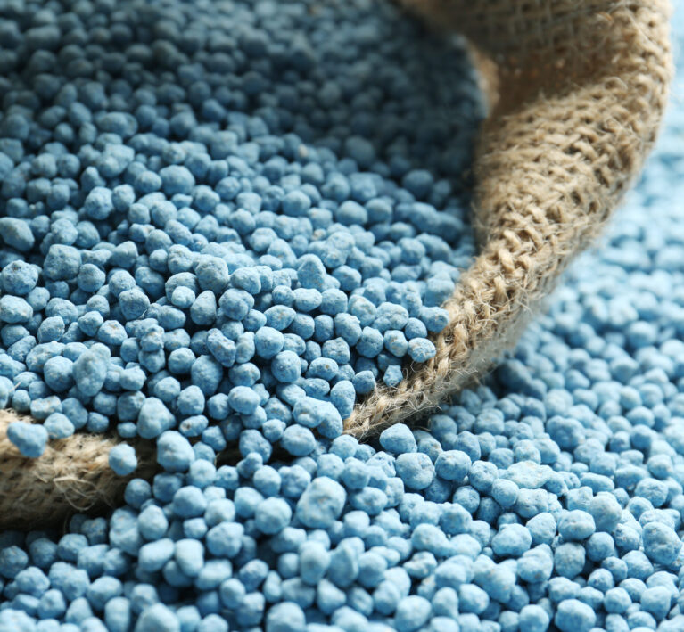 Sack bag and granular mineral fertilizer, closeup